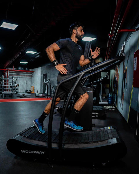 Man running on a woodway curve treadmill