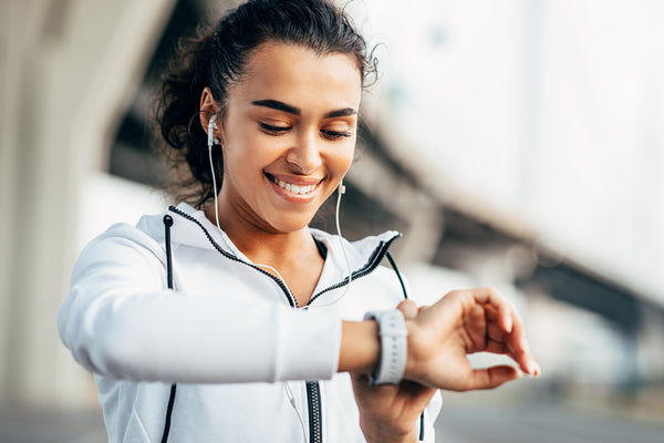 Woman ready to workout looking at her watch