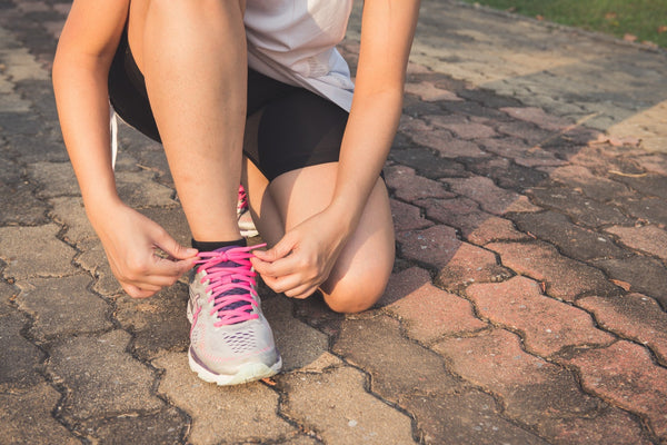 Woman tying her laces ready to run