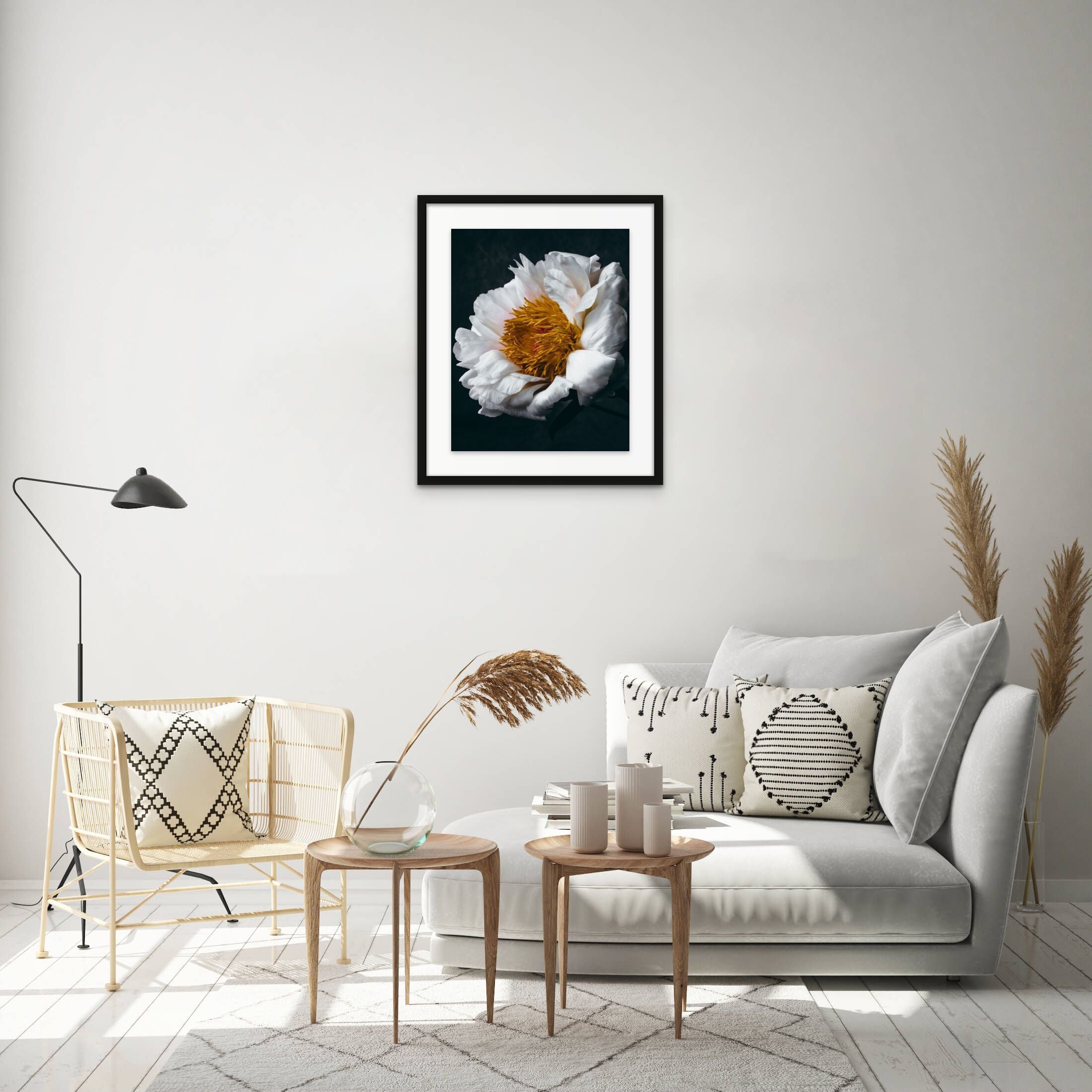 framed white and yellow flower art photo on wall above sofa and chair