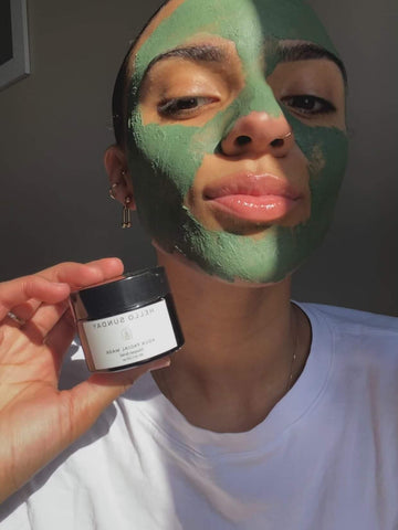 Meeca holding jar with Agua facial mask on