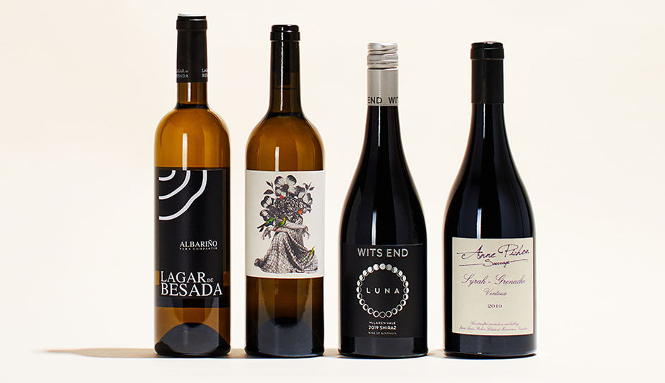 A line-up of August's four bottles. Labels are all monotone, black and white.