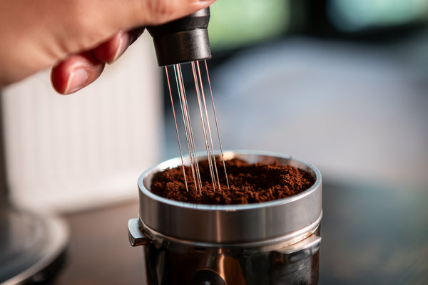 WDT tool distributing coffee grounds in portafilter