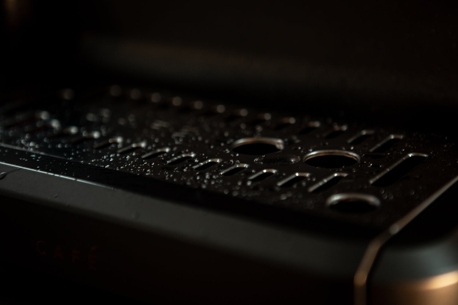 water drops on grate of espresso maker