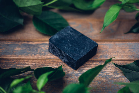 Block of charcoal on wooden table