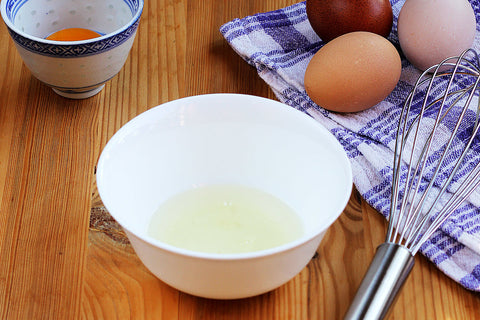 eggs on table with whisk and egg whites in bowl for egg coffee