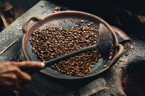 Neapolitan Roasting Method where coffee beans are turned using a ladle by hand