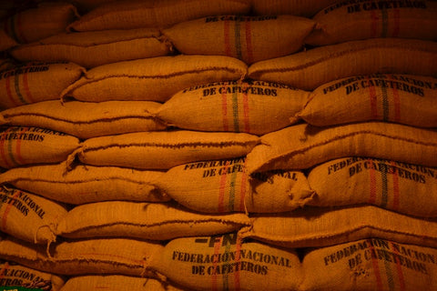 sacks of Colombian coffee beans stacked