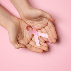 Breast Cancer Awareness Ribbon in Hands