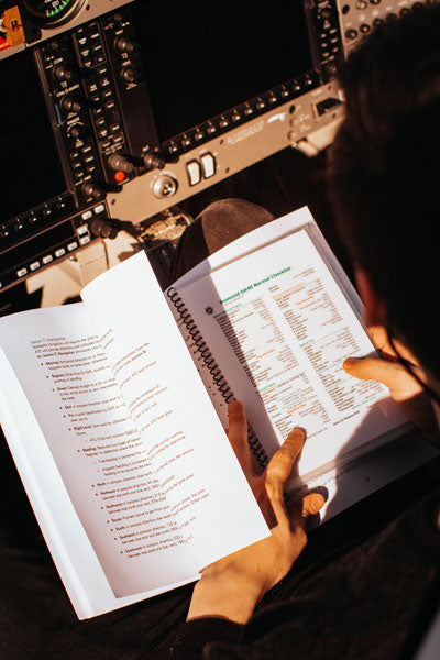 Pilot reviewing checklist