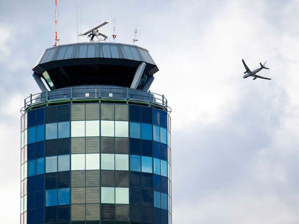 Plane flying by Air Traffic Control Tower