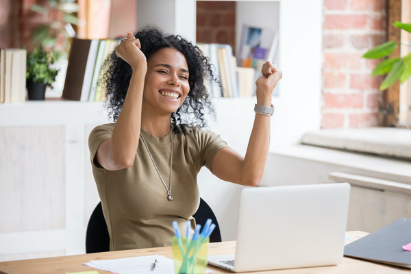 Woman Celebrating in front of Laptop