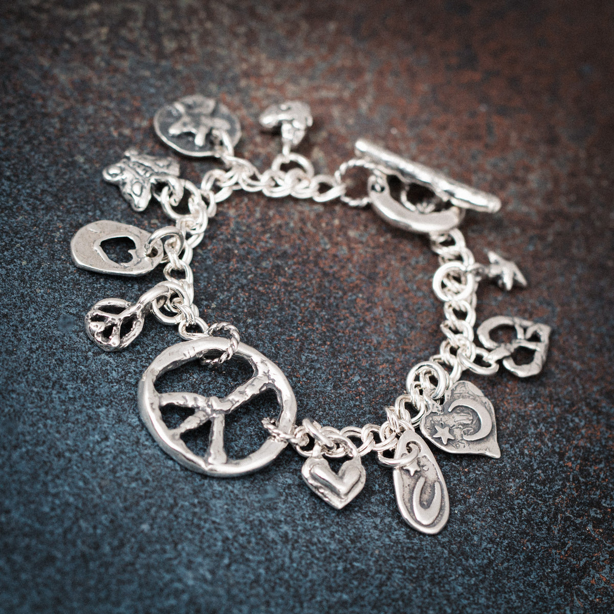 charm bracelet with peace sign hearts and butterfly
