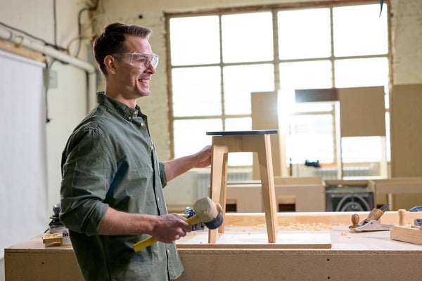 man-crafting-wooden-stool