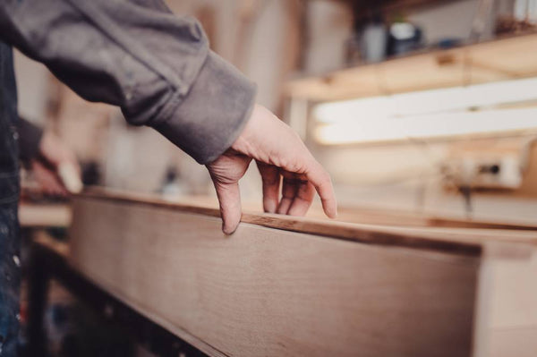 man using wooden drawer from workbench