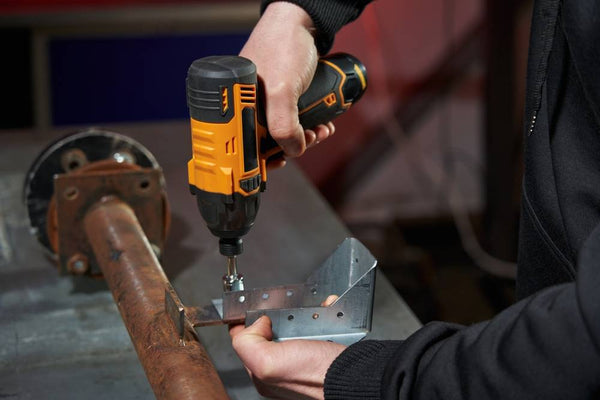 man working with electric cordless wrench