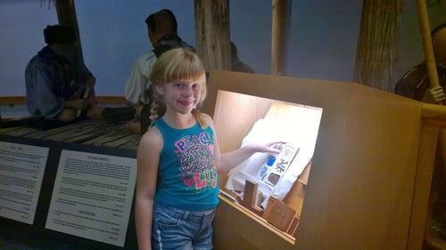 Child playing with an Atomic Carrots interactive 