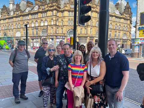 Leeds Food Tours Things to Do August Bank Holiday in Leeds. A group of 12 people stood in front of Leeds market on a food tour