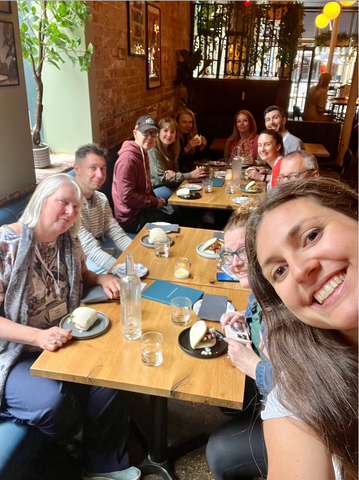 Ellen leading a food tour in Leeds, taking a selfie with the group