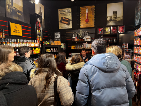 A group on a food tour of Leeds, listening and tasting at the chilli shop. A food tour is one of the best things to do in Leeds city centre