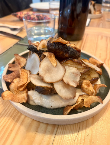 Vegetarian restaurants in Leeds - a brown plate at eat your greens with artichoke cooked four ways, including a puree, pickled, roasted and fried.