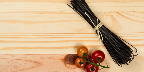 Natural black bean spaghetti on pine background. Ready for cooking.