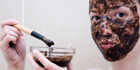 woman's face covered in coffee bean scrub