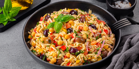 Greek Orzo Salad on a Black Plate