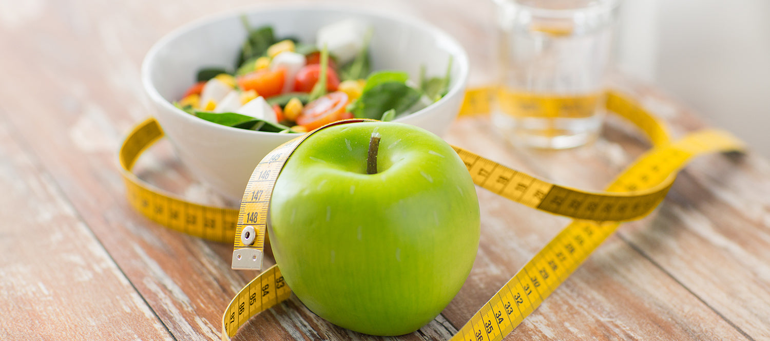 green apple with measuring tape around it