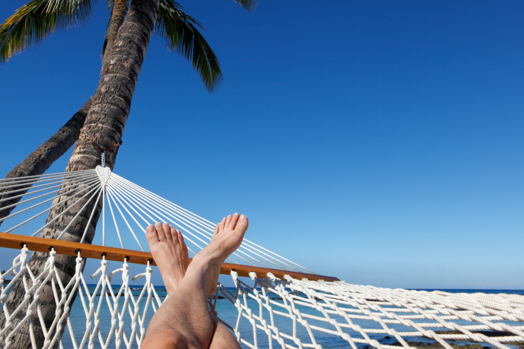 person relaxing at the beach less stress