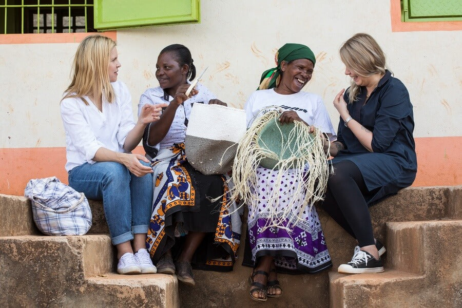 Minna and Mari weaving with artisans.