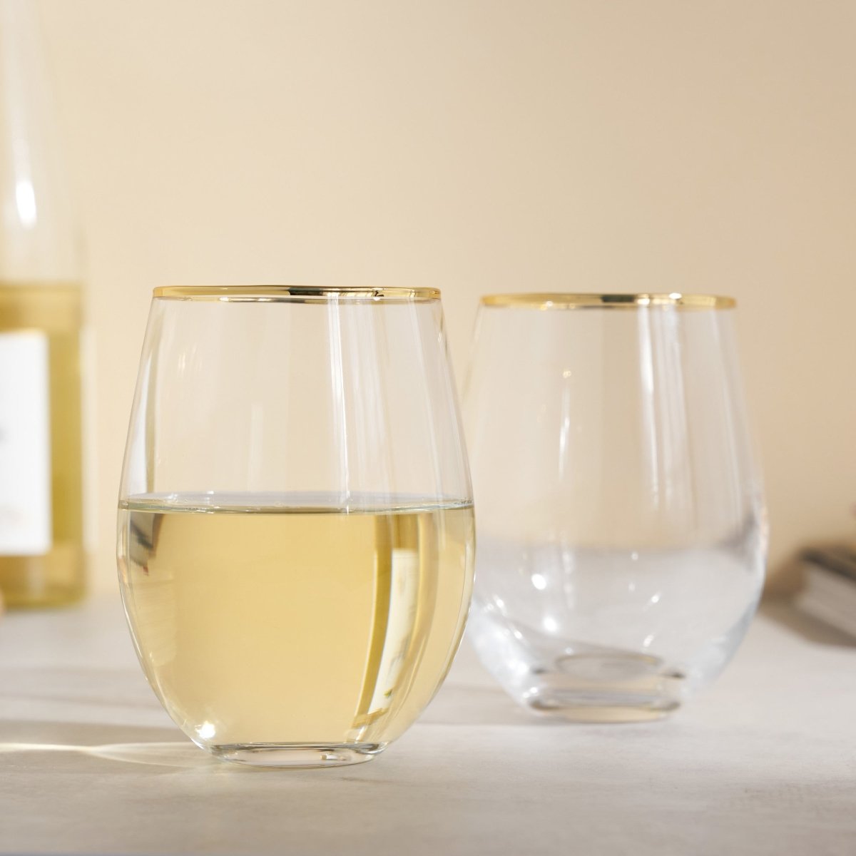 https://cdn.shopify.com/s/files/1/0275/1876/3088/products/gilded-stemless-wine-glass-set-of-2-483410_1445x.jpg?v=1666388765