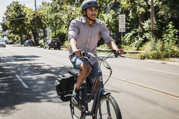 A man riding a Schwinn Mendocino electric bike on his commute to work.