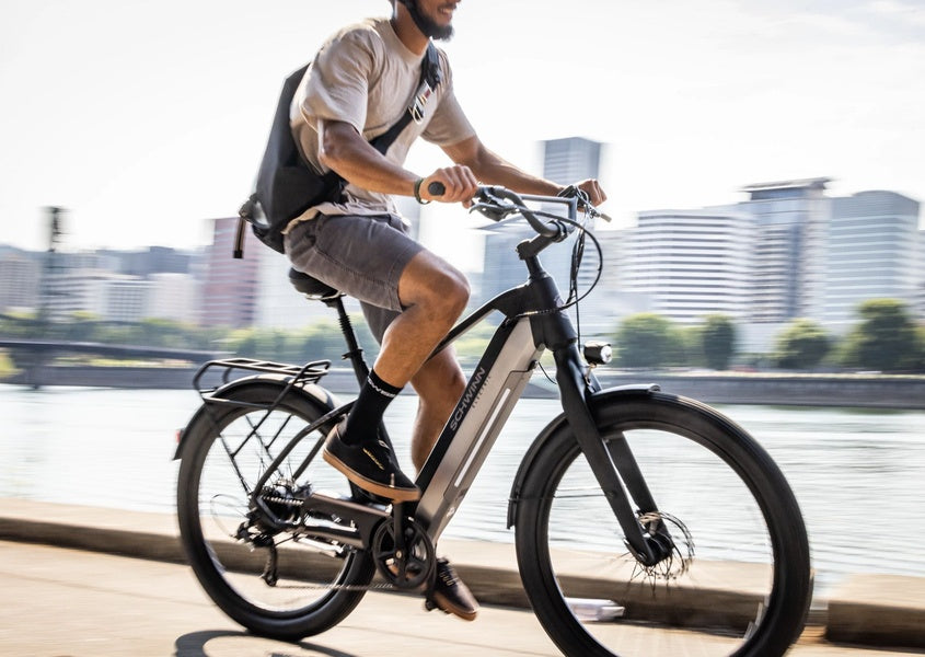 A man zipping through the city on his Schwinn electric bike.