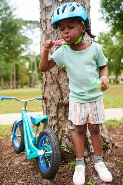 A child and her spitfire balance bike in the park