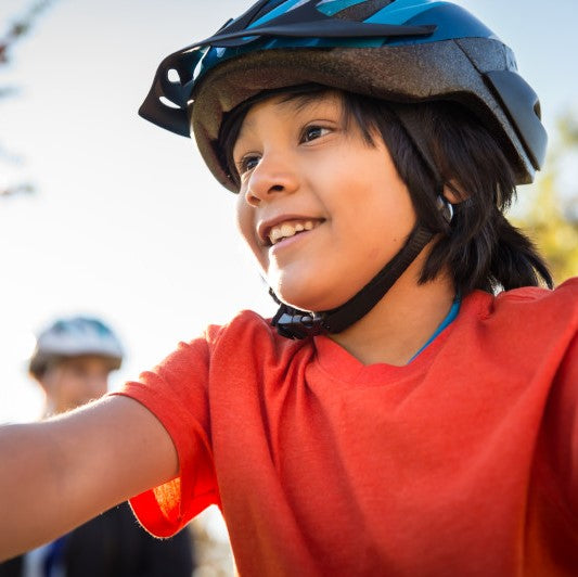 A young boy wearing a bicycle helmet