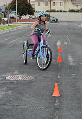 Sydney practicing for her upcoming horse race by using her trike.