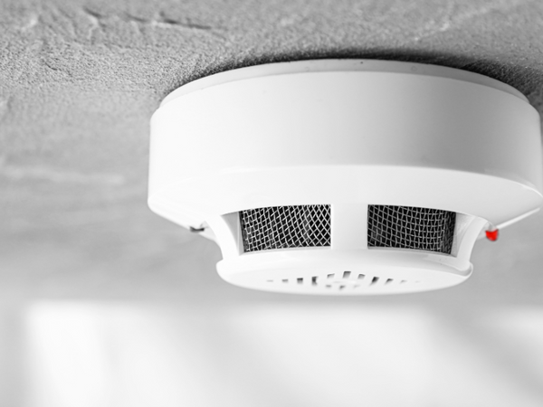 white smoke detector with a red led