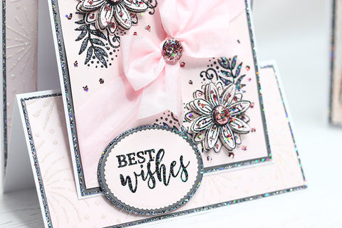 side view of pink handmade birthday card with pink flowers, ribbon and glitter embellishments