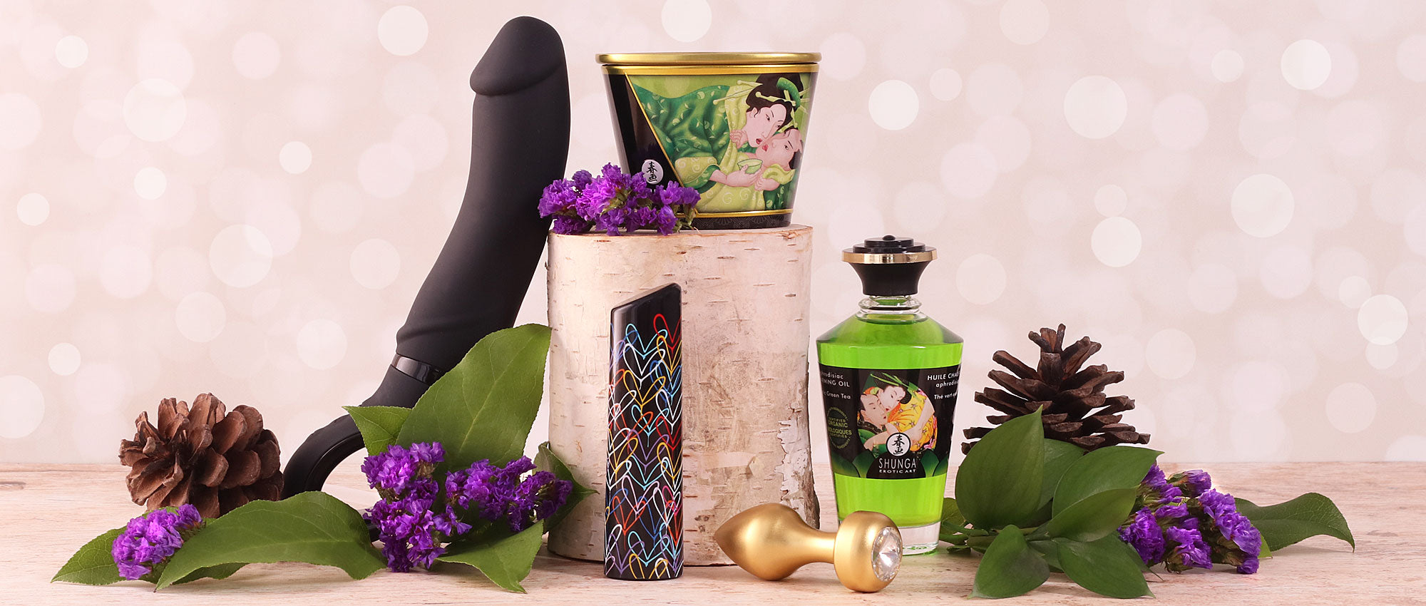 Sex toys, lubricant, massage candle, pine cones, leaves, flowers