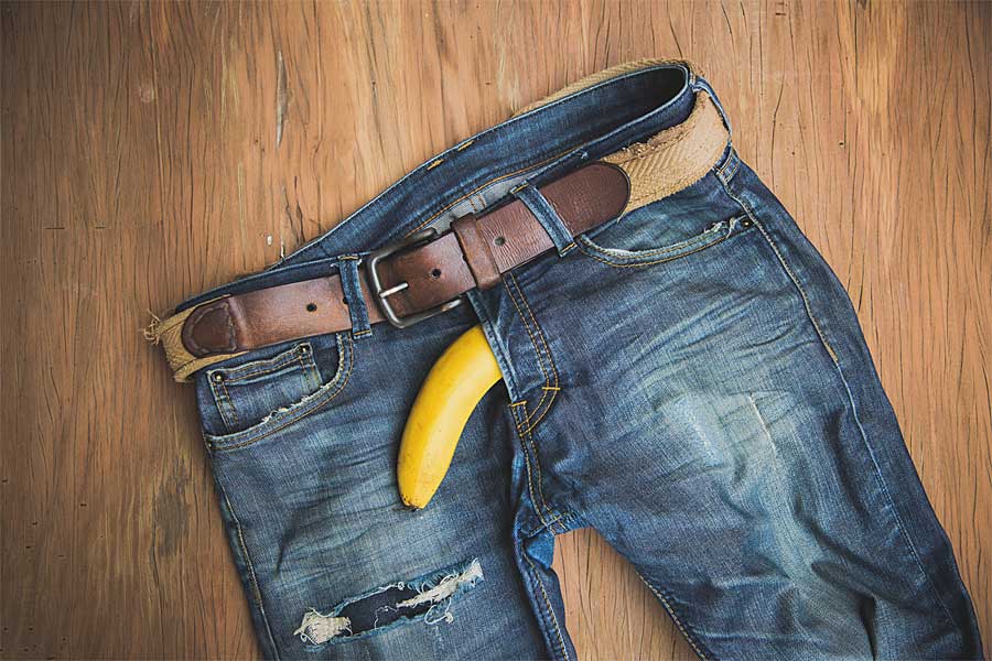 jeans on floor with banana, male castration