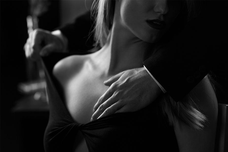 man caressing woman's shoulders, erotica