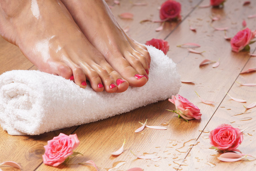 Picture of manicured feet on a towel with roses around them
