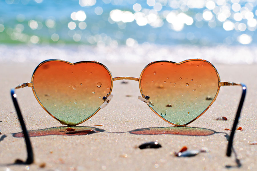 Heart shaped sunglasses on the beach