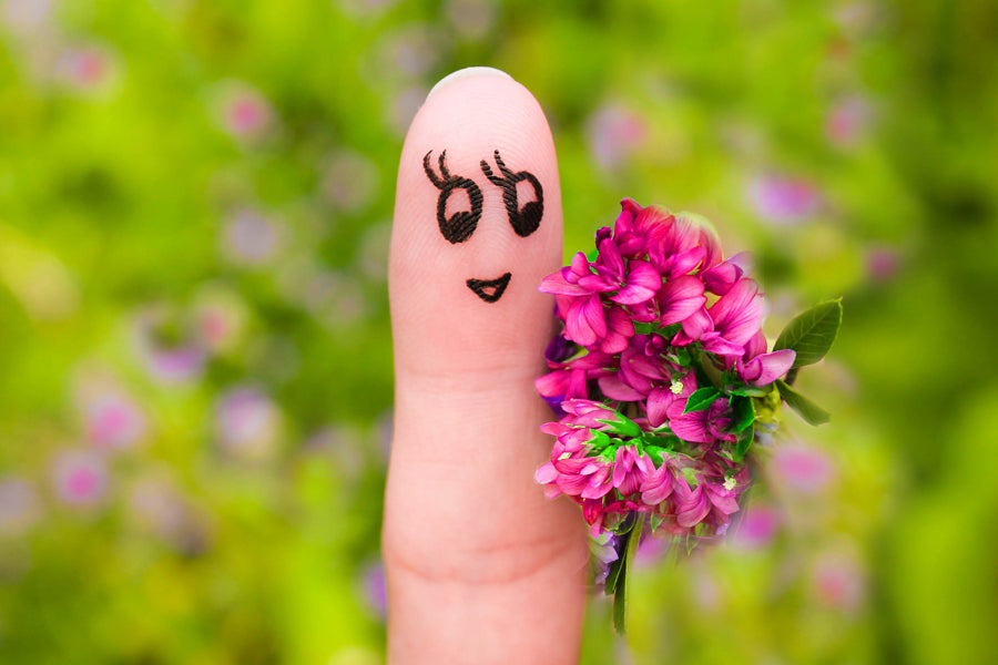 finger puppet female holding bouquet of flowers