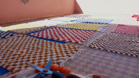 Colorful Checkered Moroccan Rugs laying in the sun 