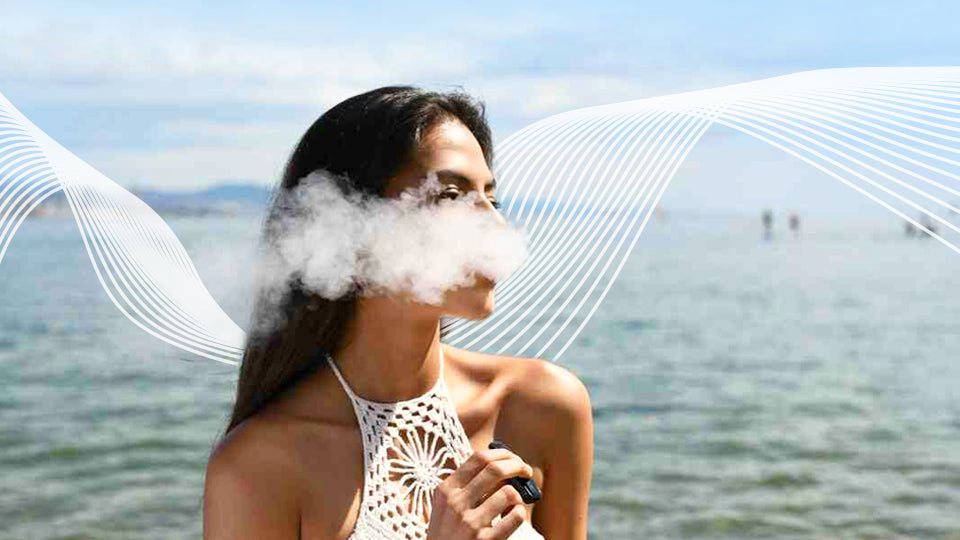 Woman vaping by water