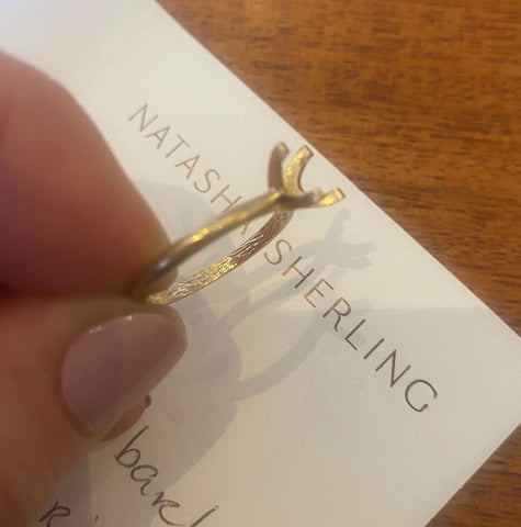 Natasha Sherling holding an engraved ring shank