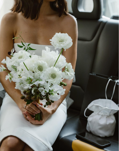 Bride-holding-white-floral-bouquet