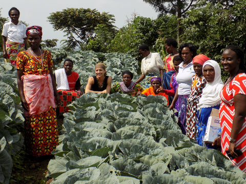 sara with women in rwanda in cabbage field